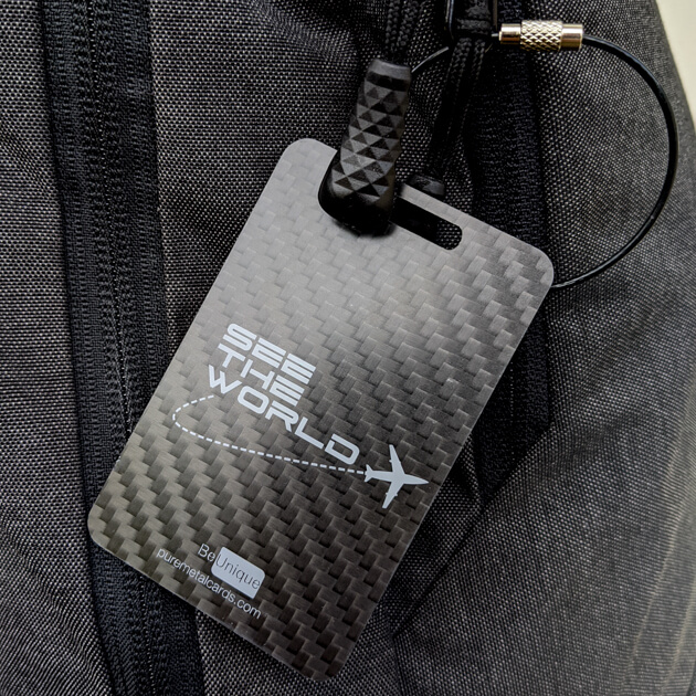 Pure Metal Cards carbon fiber luggage tag on a bag