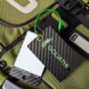 Pure Metal Cards - carbon fiber luggage tags - matte finish 3K Twill - tag with signature panel - goliath air 12 Goliath carbon fiber luggage tag attached to a green bag.