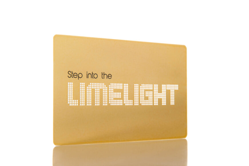 Gold metal business card with "Step into the LIMELIGHT" text. A metal business card size example.