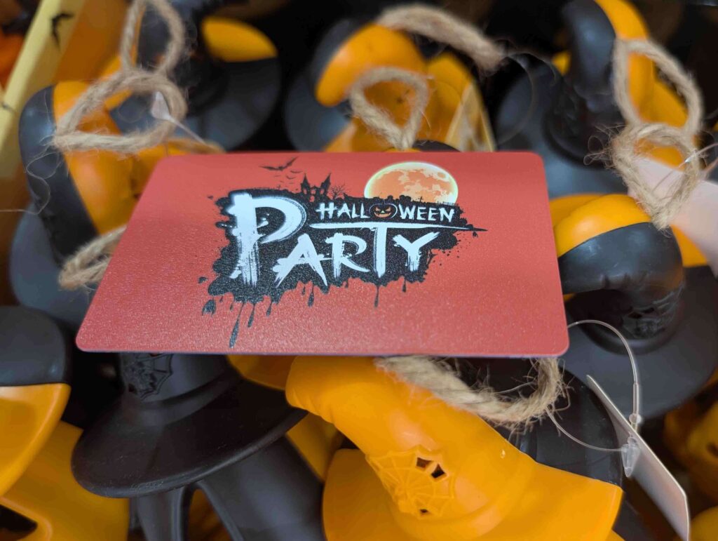 Halloween party themed Premium Metal Card display with witch hat decorations.