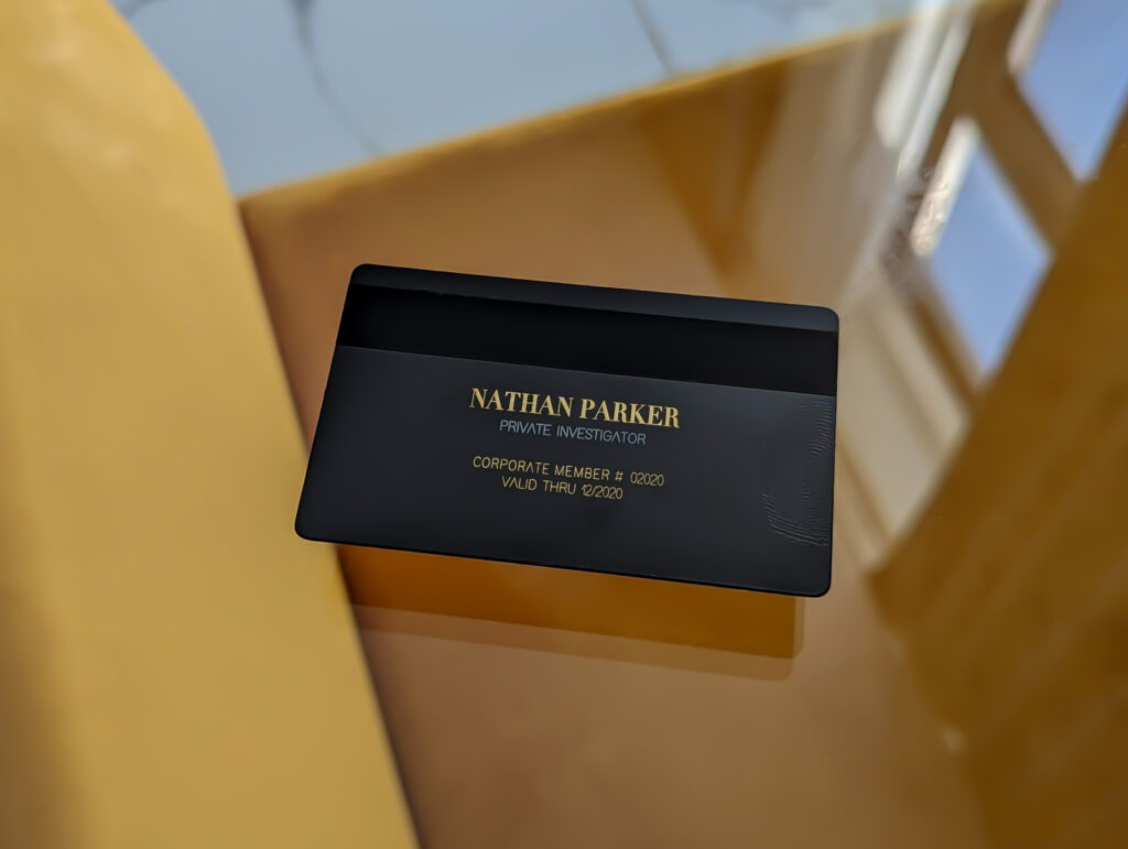 Black metal business card for Nathan Parker, Private Investigator