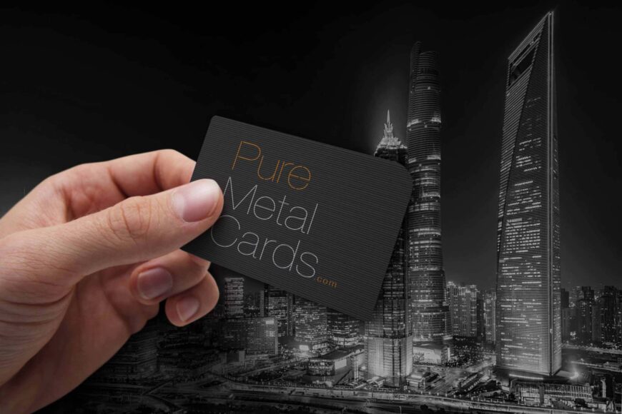 Hand holding a black Pure Metal Cards business card. Ultimate networking tool.