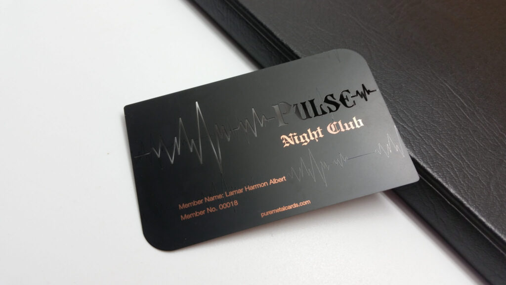 Pure Metal Cards - matt black copper member card - pulse night club resting against a black card case