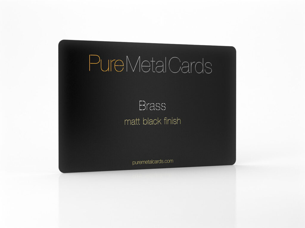 Close-up of a matte black brass card from Pure Metal Cards. Text: "Brass, matt black finish.