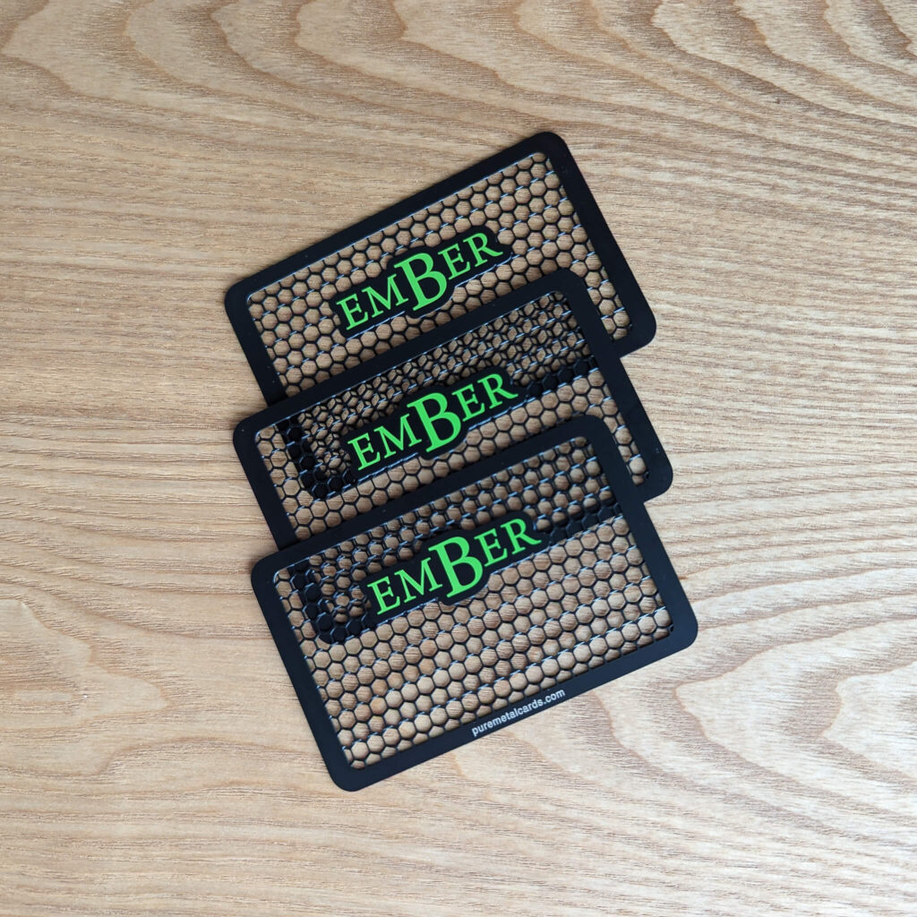 Pure Metal Cards - matt black metal grinder cards - ember with wood background