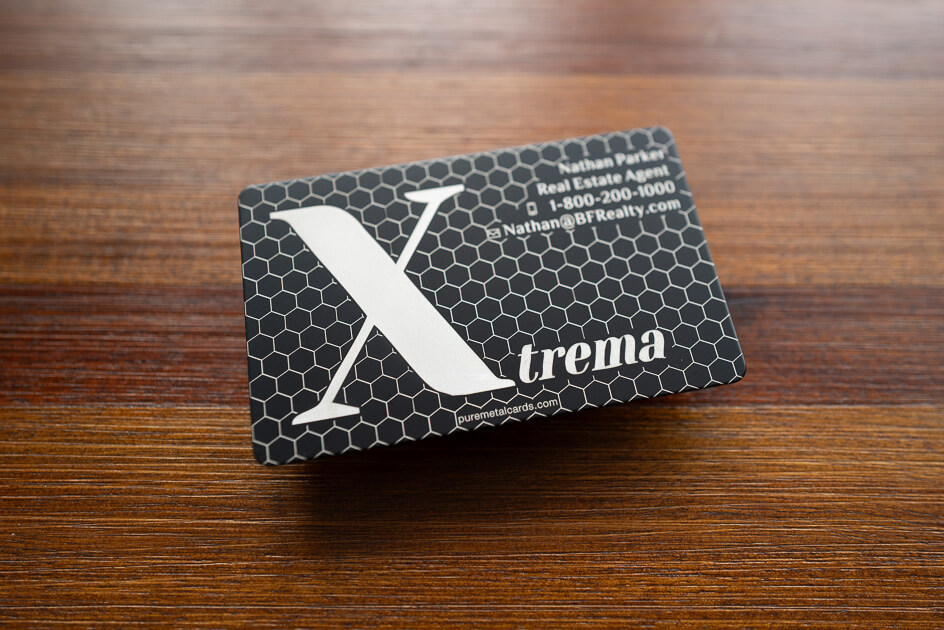 Sleek black metal business card with laser etched Xtrema logo and lettering. Metal business cards.
