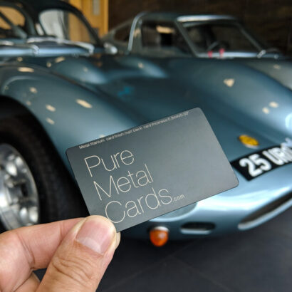 Pure Metal Cards matt black titanium business card next to ginetta cards