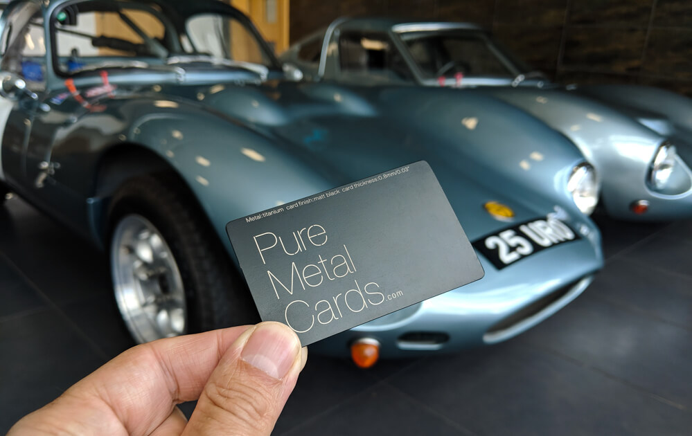 Pure Metal Cards matt black titanium business card next to ginetta cards