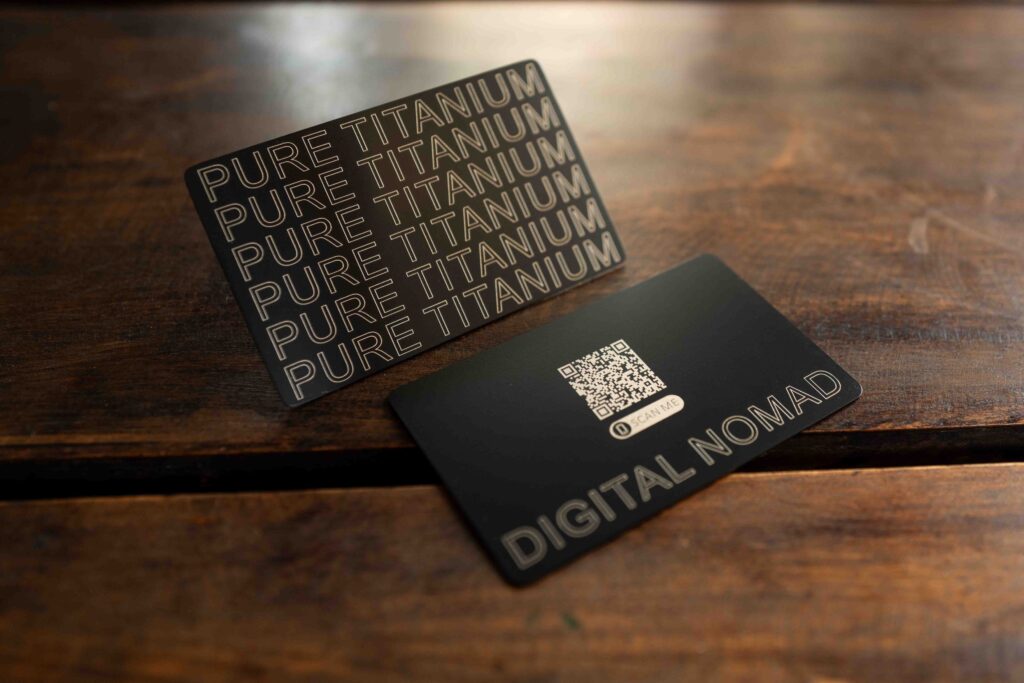 Black metal business cards: "Pure Titanium" and "Digital Nomad" with a QR code by puremetalcards.com