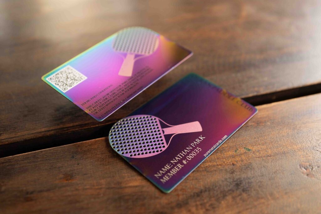 Metal member cards for a ping pong club, showing iridescent finish and club logo. Text: "Nathan Park, Member #00035