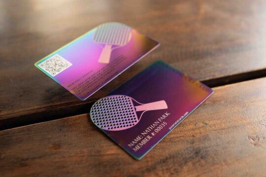 Metal member cards for a ping pong club, showing iridescent finish and club logo. Text: "Nathan Park, Member #00035