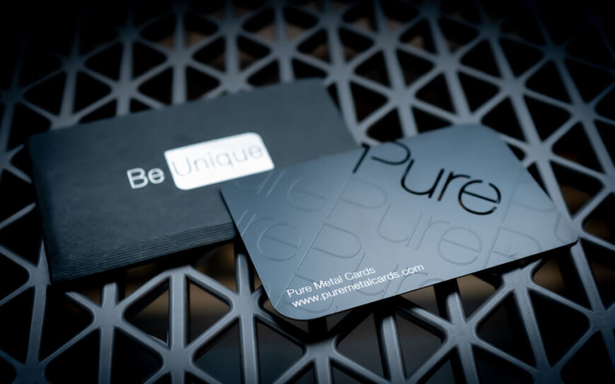Black metal business card with "Pure" text on a dark mesh surface