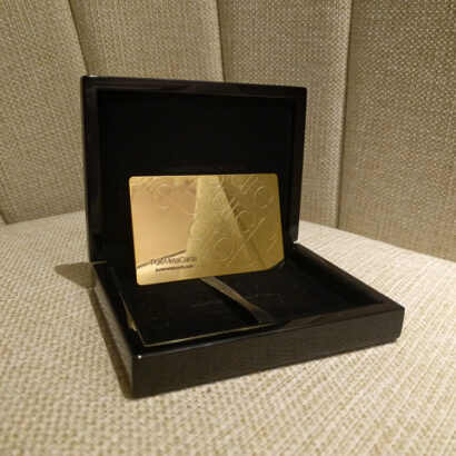 Gold engraved metal business card in a black presentation box