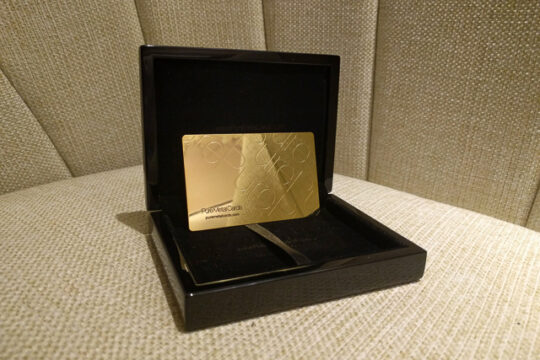 Gold engraved metal business card in a black presentation box