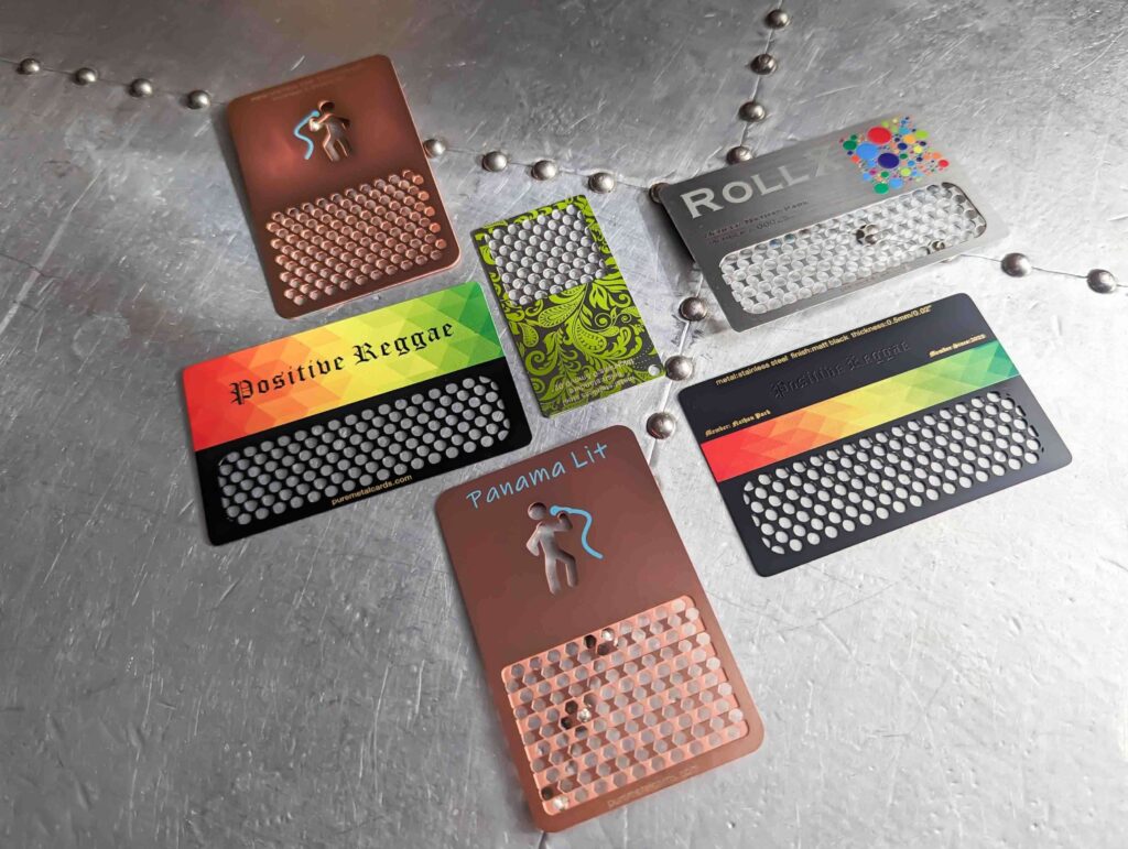 Metal grinder cards with various designs, including "Positive Reggae" and "Panama Lit" from Pure Metal Cards.