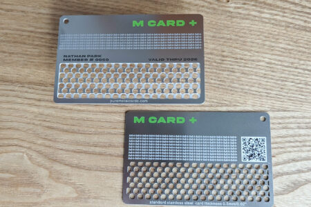 Pure Metal Cards - standard stainless steel metal grinder cards - m card plus on wood background